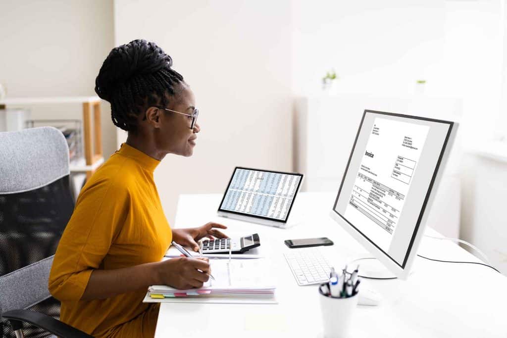 African American Woman working in an office doing spreadsheets